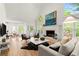 Bright open concept with hardwood floors, a fireplace, and adjacent dining area at 5620 Preserve Cir, Johns Creek, GA 30005
