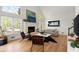 Bright living room with a fireplace, large windows, hardwood floors, and stylish decor at 5620 Preserve Cir, Johns Creek, GA 30005