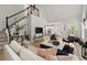 Bright living room featuring an open floor plan, hardwood floors, and modern decor at 5620 Preserve Cir, Johns Creek, GA 30005