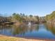 Scenic pond with a fountain and surrounding trees, enhancing the community's natural beauty at 5620 Preserve Cir, Johns Creek, GA 30005