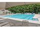Community pool featuring lounge chairs and a large awning for shade on a sunny day at 5620 Preserve Cir, Johns Creek, GA 30005