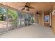 An expansive screened porch featuring ceiling fans and lush landscaping, seamlessly blending indoor and outdoor living at 5620 Preserve Cir, Johns Creek, GA 30005