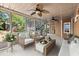 Inviting screened porch featuring comfortable seating, ceiling fans, and views of the landscaped yard at 5620 Preserve Cir, Johns Creek, GA 30005