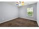 Bedroom featuring neutral walls, carpet, and a colorful ceiling fan at 5654 Lawley Dr, Alpharetta, GA 30022
