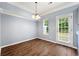 Bright dining area featuring wood floors, natural light, and modern light fixture at 5654 Lawley Dr, Alpharetta, GA 30022