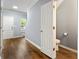 Hallway with wood-look flooring features a half-bath and a view into the stairwell at 5654 Lawley Dr, Alpharetta, GA 30022