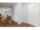 Open hallway features wood-look flooring with a view into the main living area with fireplace at 5654 Lawley Dr, Alpharetta, GA 30022