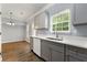 Kitchen area with gray cabinets, white countertops, and stainless steel dishwasher at 5654 Lawley Dr, Alpharetta, GA 30022