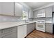 Well-lit kitchen featuring gray cabinets, white countertops, and stainless steel appliances at 5654 Lawley Dr, Alpharetta, GA 30022