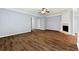 Spacious living room features wood-look flooring, a fireplace, and an open archway at 5654 Lawley Dr, Alpharetta, GA 30022