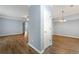 Open living space featuring wood floors, gray walls, and modern light fixtures at 5654 Lawley Dr, Alpharetta, GA 30022
