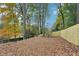 A sprawling backyard features a new wooden privacy fence and mature trees for peaceful outdoor living at 2396 Sunset Ne Dr, Atlanta, GA 30345