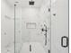 Modern bathroom featuring glass shower with striking tile patterns and black fixtures at 2396 Sunset Ne Dr, Atlanta, GA 30345