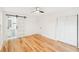 Bright bedroom with hardwood floors, a barn-style door to the bathroom, and double door closet at 2396 Sunset Ne Dr, Atlanta, GA 30345