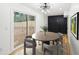 Bright dining room with hardwood floors, sliding glass door, dark accent wall, and modern chandelier at 2396 Sunset Ne Dr, Atlanta, GA 30345
