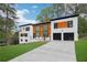 Modern two-story home featuring a concrete driveway, two-car garage, and eye-catching architectural details at 2396 Sunset Ne Dr, Atlanta, GA 30345