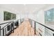Second story hallway featuring hardwood floors and views of the surrounding treeline at 2396 Sunset Ne Dr, Atlanta, GA 30345