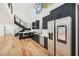 Modern kitchen with stainless steel appliances, hardwood floors, and staircase leading to a second story at 2396 Sunset Ne Dr, Atlanta, GA 30345
