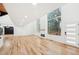 Bright and airy living room featuring hardwood floors, a fireplace, and large windows offering beautiful views at 2396 Sunset Ne Dr, Atlanta, GA 30345