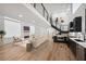 Bright open-concept living room with hardwood floors, fireplace, and modern kitchen featuring stainless steel appliances at 2396 Sunset Ne Dr, Atlanta, GA 30345