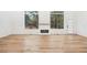 Bright living room featuring hardwood floors, fireplace, and large windows providing natural light and outdoor view at 2396 Sunset Ne Dr, Atlanta, GA 30345