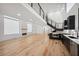 A spacious living room with hardwood floors, a modern staircase, and an open floor plan leading to the kitchen at 2396 Sunset Ne Dr, Atlanta, GA 30345