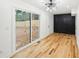 Bright living room with hardwood floors, sliding glass door, and a dark accent wall at 2396 Sunset Ne Dr, Atlanta, GA 30345