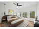 Well-lit bedroom with hardwood floors, ceiling fan, and sliding glass doors at 2396 Sunset Ne Dr, Atlanta, GA 30345