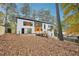 Contemporary home with modern white siding and wooden accents, featuring a private deck and walkout basement at 2396 Sunset Ne Dr, Atlanta, GA 30345