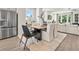 Open concept dining area with modern furnishings and a seamless flow to the living room at 407 Nix Ln, Lawrenceville, GA 30046