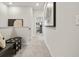 Hallway featuring carpeted floors, artwork, and a bench with throw pillow at 407 Nix Ln, Lawrenceville, GA 30046