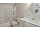 Well-lit bathroom featuring white tile, a shower-tub combination, and a white marble vanity at 519 2Nd Ave, Decatur, GA 30030