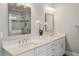 Luxurious bathroom with dual sinks, marble countertops, white cabinets, and a glass-enclosed shower at 519 2Nd Ave, Decatur, GA 30030