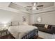 Serene bedroom with hardwood floors, a ceiling fan, and a plush bed with a comfortable seating area for relaxing at 519 2Nd Ave, Decatur, GA 30030