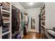 Spacious walk-in closet with custom shelves and hardwood floors to organize clothes, shoes, and accessories at 519 2Nd Ave, Decatur, GA 30030