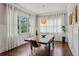 Dining room with large windows, modern lighting, hardwood floors and light walls at 519 2Nd Ave, Decatur, GA 30030