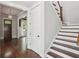 Inviting entryway with hardwood floors, white trim, and a staircase leading to the upper level at 519 2Nd Ave, Decatur, GA 30030