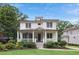 Inviting two-story home with a classic front porch and lush green lawn at 519 2Nd Ave, Decatur, GA 30030