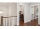 Hallway features hardwood floors, white trim, doors, laundry area and a light fixture at 519 2Nd Ave, Decatur, GA 30030