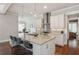 Gorgeous kitchen featuring white cabinets, an island with seating and a view to the dining room at 519 2Nd Ave, Decatur, GA 30030