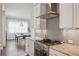 Modern kitchen features stainless steel appliances, granite counters, and light gray herringbone backsplash at 519 2Nd Ave, Decatur, GA 30030