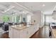 Spacious kitchen boasts a large island, stainless steel sink, and open layout to the living room at 519 2Nd Ave, Decatur, GA 30030
