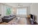 Bright living room features hardwood floors, a leather sofa, large windows, and modern decor at 519 2Nd Ave, Decatur, GA 30030