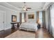 Main bedroom features a tray ceiling, hardwood floors, neutral paint, and large windows at 519 2Nd Ave, Decatur, GA 30030