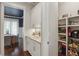 Well-organized pantry with shelving, countertop, cabinets and a glimpse of the adjacent butler's pantry at 519 2Nd Ave, Decatur, GA 30030