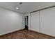 Bedroom featuring wood floors and closet for ample storage at 655 Barrington Way, Roswell, GA 30076