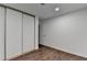 Bright bedroom featuring wood-look flooring and a closet with sliding doors at 655 Barrington Way, Roswell, GA 30076