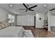 Bright bedroom featuring wood floors, ceiling fan, and large closet for ample storage at 655 Barrington Way, Roswell, GA 30076