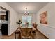Charming dining room with a wooden table set, chandelier lighting, and floral artwork at 655 Barrington Way, Roswell, GA 30076