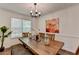 Inviting dining room featuring a rustic table set, floral art, and bright window light at 655 Barrington Way, Roswell, GA 30076
